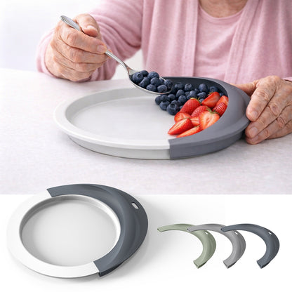Person scooping food against a plate guard