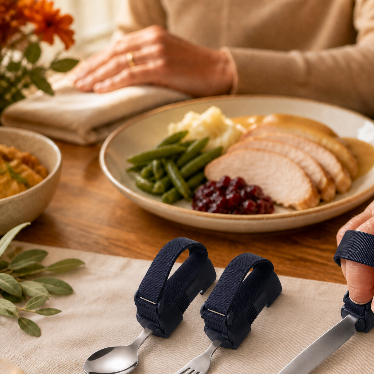 Deep navy adaptive spoon, fork and knife set at a warm family meal